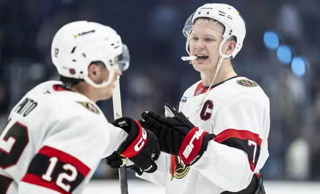 Ottawa Senators forward Brady Tkachuk, right, and forward Shane Pinto celebrate after an NHL hockey game against the Seattle Kraken Saturday, March 7, 2026, in Seattle. (AP Photo/Stephen Brashear)