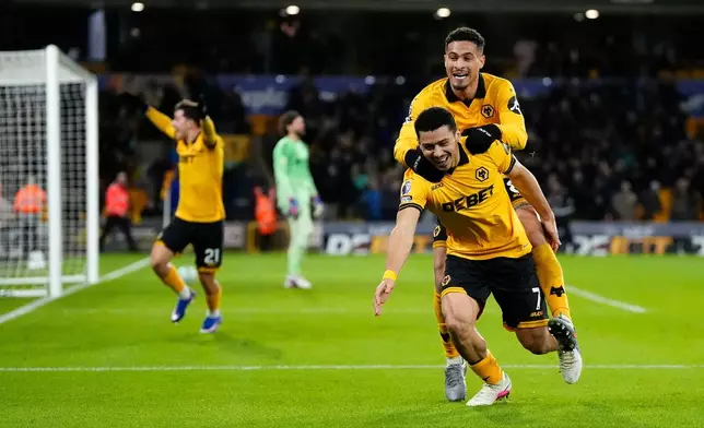 Wolverhampton Wanderers' Andre, front right, celebrates after scoring their second goal of the game during an English Premier League match against Liverpool, Tuesday, March 3, 2026, in Wolverhampton, England. (Nick Potts/PA via AP)