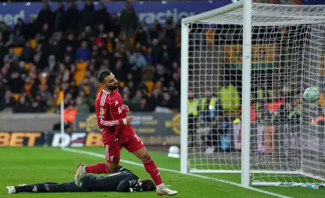 Liverpool's Mohamed Salah scores his side's opening goal during the English Premier League soccer match between Wolverhampton Wanderers and Liverpool in Wolverhampton, England, Tuesday, March 3, 2026. (AP Photo/Dave Shopland)