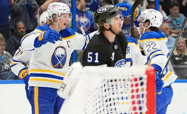 Buffalo Sabres defenseman Rasmus Dahlin, left, celebrates his goal against the Tampa Bay Lightning with right wing Jack Quinn, right, during the first period of an NHL hockey game Saturday, Feb. 28, 2026, in Tampa, Fla. (AP Photo/Chris O'Meara)