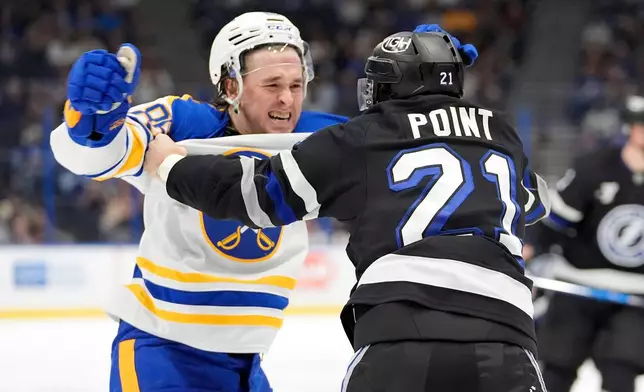 Tampa Bay Lightning center Brayden Point (21) and Buffalo Sabres center Noah Ostlund (86) scrap during the second period of an NHL hockey game Saturday, Feb. 28, 2026, in Tampa, Fla. (AP Photo/Chris O'Meara)