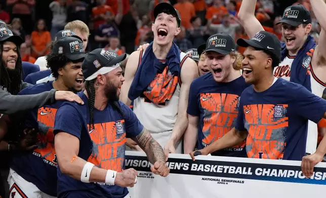 Illinois players celebrate after beating Iowa in an Elite Eight game in the NCAA college basketball tournament Saturday, March 28, 2026, in Houston. (AP Photo/Ashley Landis)