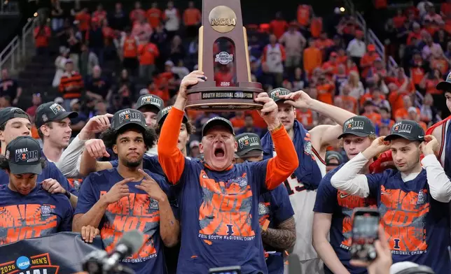 Illinois' Brad Underwood, center, celebrates with players after an Elite Eight game against Iowa in the NCAA college basketball tournament Saturday, March 28, 2026, in Houston. (AP Photo/Ashley Landis)