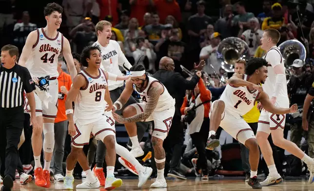 Illinois players celebrate after beating Iowa in an Elite Eight game in the NCAA college basketball tournament Saturday, March 28, 2026, in Houston. (AP Photo/Ashley Landis)