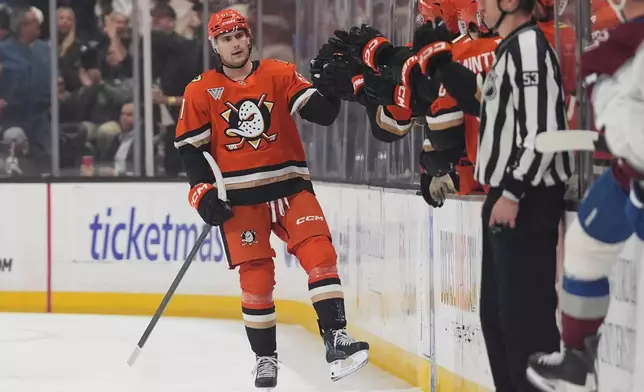 Anaheim Ducks left wing Cutter Gauthier, left, celebrates his goal with teammates during the second period of an NHL hockey game against the Colorado Avalanche Tuesday, March 3, 2026, in Anaheim, Calif. (AP Photo/Gregory Bull)