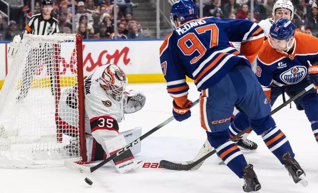 Ottawa Senators goaltender Linus Ullmark (35) makes the save on Edmonton Oilers' Connor McDavid (97) during second period NHL action, in Edmonton on Tuesday, March 3, 2026. (Jason Franson/The Canadian Press via AP)