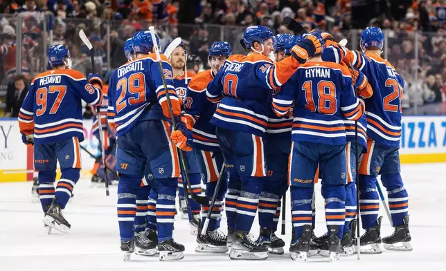 Edmonton Oilers players celebrate the win over the Ottawa Senators in overtime NHL action, in Edmonton on Tuesday, March 3, 2026. (Jason Franson/The Canadian Press via AP)