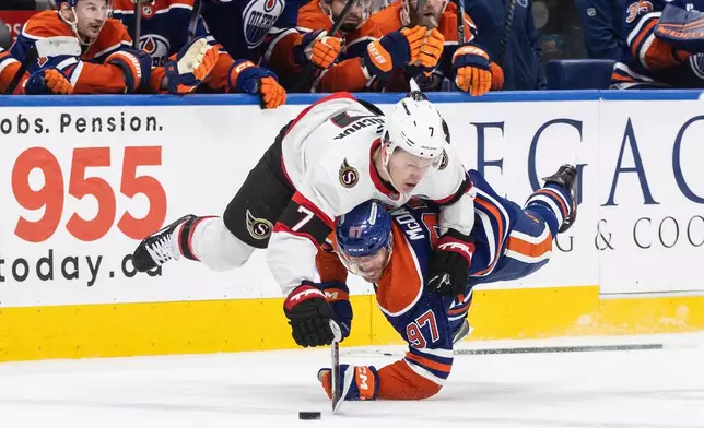 Ottawa Senators' Brady Tkachuk (7) checks Edmonton Oilers' Connor McDavid (97) during overtime NHL action, in Edmonton on Tuesday, March 3, 2026. (Jason Franson/The Canadian Press via AP)