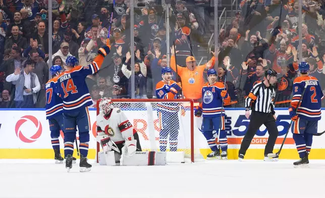 Edmonton Oilers players celebrate a goal as Ottawa Senators goaltender Linus Ullmark (35) looks on during third period NHL action, in Edmonton on Tuesday, March 3, 2026. (Jason Franson/The Canadian Press via AP)