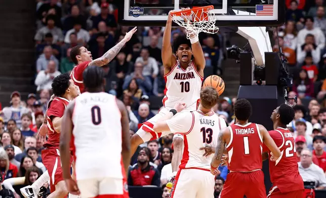 Arizona forward Koa Peat (10) dunks during the first half in the Sweet 16 of the NCAA college basketball tournament against Arkansas, Thursday, March 26, 2026, in San Jose, Calif. (AP Photo/Kelley L Cox)