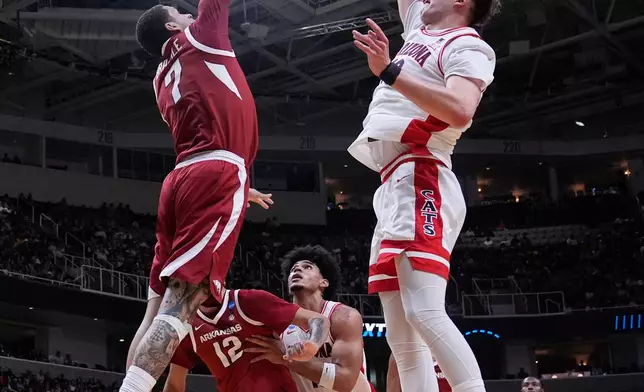 Arizona center Motiejus Krivas (13) shoots over Arkansas forward Trevon Brazile (7) during the first half in the Sweet 16 of the NCAA college basketball tournament, Thursday, March 26, 2026, in San Jose, Calif. (AP Photo/Godofredo A. Vásquez)
