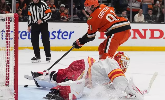 Anaheim Ducks center Leo Carlsson, above scores past Calgary Flames goaltender Devin Cooley during a shootout in an NHL hockey game Sunday, March 1, 2026, in Anaheim, Calif. (AP Photo/Gregory Bull)