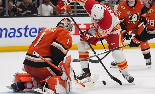Calgary Flames center Nazem Kadri tries to shoot as Anaheim Ducks goaltender Lukas Dostal (1) defends during the second period of an NHL hockey game Sunday, March 1, 2026, in Anaheim, Calif. (AP Photo/Gregory Bull)