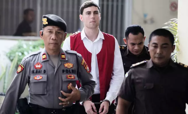 Australian national Darcy Jenson, center, who is on trial for the fatal shooting of an Australian tourist last year, arrives for his sentencing hearing at the district court, in Denpasar, Bali, Indonesia, Monday, March 9, 2026. (AP Photo/Firdia Lisnawati)
