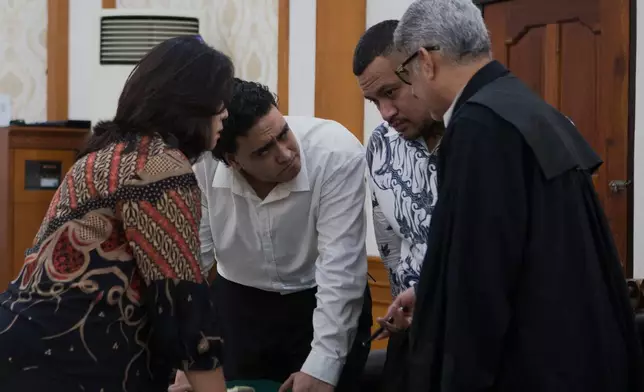 Australian nationals Paea I Middlemore Tupou, second right, and Mevlut Coskun, second left, who are on trial for the fatal shooting of an Australian tourist last year, consult with their lawyer during their sentencing hearing at the district Court, in Denpasar, Bali, Indonesia, Monday, March 9, 2026. (AP Photo/Firdia Lisnawati)