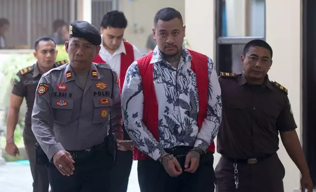 Australian nationals Paea I Middlemore Tupou, foreground center and Mevlut Coskun, rear, who are on trial for the fatal shooting of an Australian tourist last year, arrive for their sentencing hearing at the district Court in Denpasar, Bali, Indonesia, Monday, March 9, 2026. (AP Photo/Firdia Lisnawati)