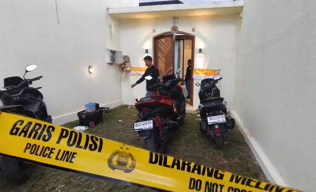 FILE - Plain-clothed police officers are seen at a villa where a shooting that led to the death of an Australian man reportedly occurred, in Badung on the resort island of Bali, Indonesia, Saturday, June 14, 2025. (AP Photo, File)