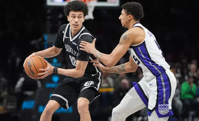 Sacramento Kings' Nique Clifford (5) defends Brooklyn Nets' Nolan Traore (88) during the second half of an NBA basketball game Sunday, March 29, 2026, in New York. (AP Photo/Frank Franklin II)