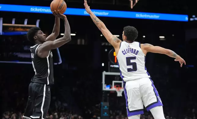 Brooklyn Nets' Drake Powell, left, shoots over Sacramento Kings' Nique Clifford during the second half of an NBA basketball game Sunday, March 29, 2026, in New York. (AP Photo/Frank Franklin II)