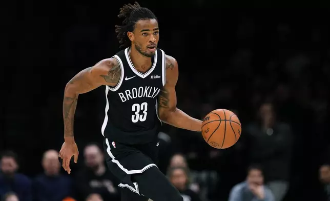 Brooklyn Nets' Nic Claxton (33) looks to pass during the second half of an NBA basketball game against the Sacramento Kings Sunday, March 29, 2026, in New York. (AP Photo/Frank Franklin II)