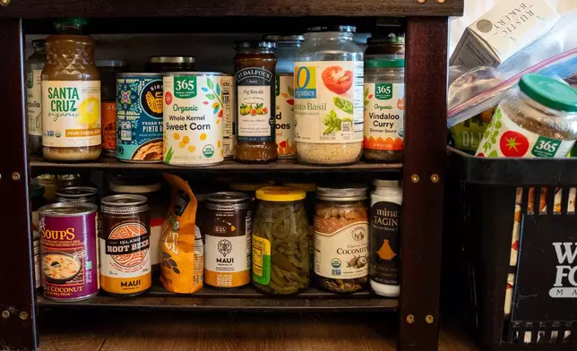 Dry goods purchased with support from a monthly cash assistance program sit in the converted hotel room where Mari Younger lives after being displaced by the Maui fires two years prior, in Kihei, Hawaii, Wednesday, March 4, 2026. (AP Photo/Mengshin Lin)