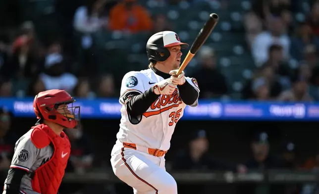 Baltimore Orioles' Adley Rutschman follows through on a one-run double against the Minnesota Twins to score the go-ahead run during the seventh inning of an MLB baseball game, Sunday, March 29, 2026 in Baltimore. (AP Photo/Gail Burton)