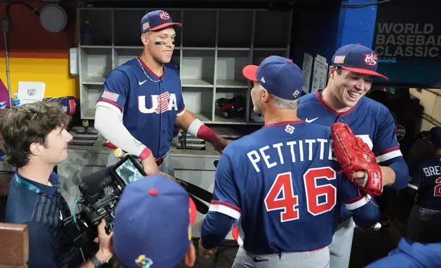 The United States team celebrates after defeating the Dominican Republic at a World Baseball Classic semifinal game, Sunday, March 15, 2026, in Miami. (AP Photo/Lynne Sladky)