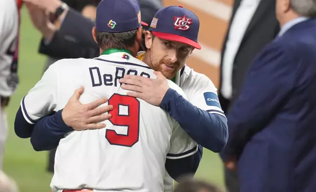United States manager Mark DeRosa hugs starting pitcher Nolan McLean at the end of the championship game of the World Baseball Classic against Venezuela, Tuesday, March 17, 2026, in Miami. (AP Photo/Lynne Sladky)