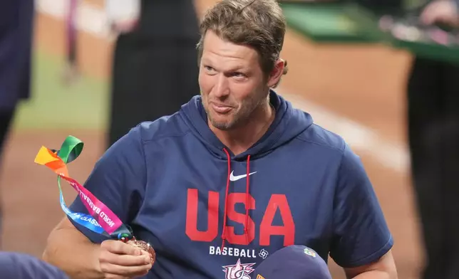 Former MLB player Clayton Kershaw carries a silver medal after the championship game of the World Baseball Classic against Venezuela, Tuesday, March 17, 2026, in Miami. (AP Photo/Lynne Sladky)