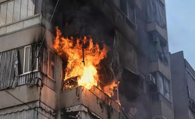 Smoke and flame rise from a residential building following an Israeli airstrike in central Beirut, Lebanon, Wednesday, March 18, 2026. (AP Photo/Bilal Hussein)