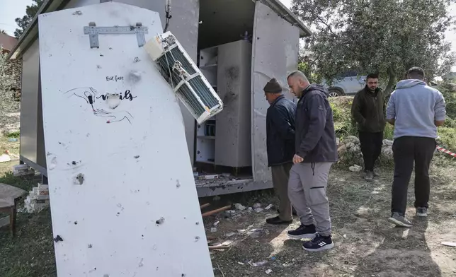 Palestinians inspect the damage at a beauty salon after a deadly Iranian strike in the West Bank village of Beit Awa, near Hebron, Thursday, March 19, 2026. (AP Photo/Mahmoud Illean)