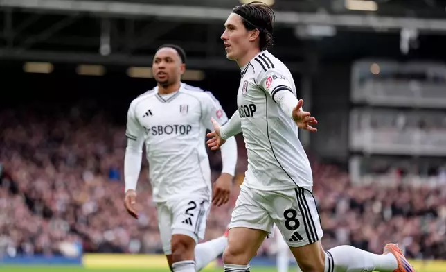 Fulham's Harry Wilson, right, celebrates after scoring his sides first goal during the English Premier League soccer match between Fulham and Tottenham in London, Sunday, March 1, 2026. (John Walton/PA via AP)