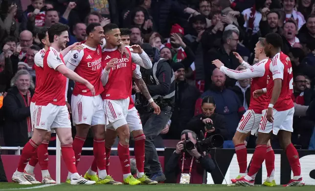 Arsenal players celebrate after a goal during the Premier League soccer match between Chelsea Arsenal in London Sunday, March 1, 2026. (AP Photo/Alastair Grant)