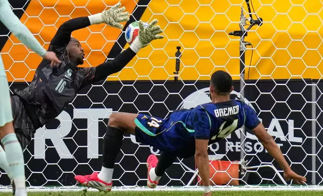 Brazil's Bremer scores his side's first goal past France goalkeeper Mike Maignan during the international friendly soccer match between Brazil and France in Foxborough, Mass, Thursday, March 26, 2026. (AP Photo/Charles Krupa)