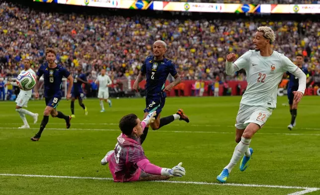 Hugo Ekitike of France scores his side's second goal past Brazilian goalkeeper Ederson during the international friendly soccer match between Brazil and France in Foxborough, Mass, Thursday, March 26, 2026. (AP Photo/Charles Krupa)
