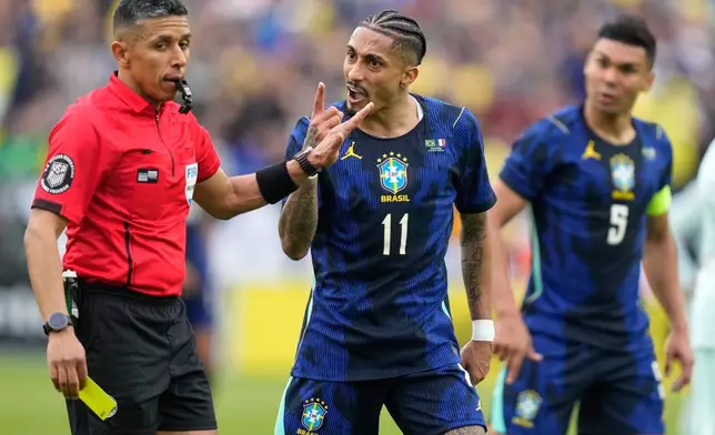 Brazil's Raphinha gestures at referee Guido Gonzales Jr. during the international friendly soccer match between Brazil and France in Foxborough, Mass, Thursday, March 26, 2026. (AP Photo/Charles Krupa)