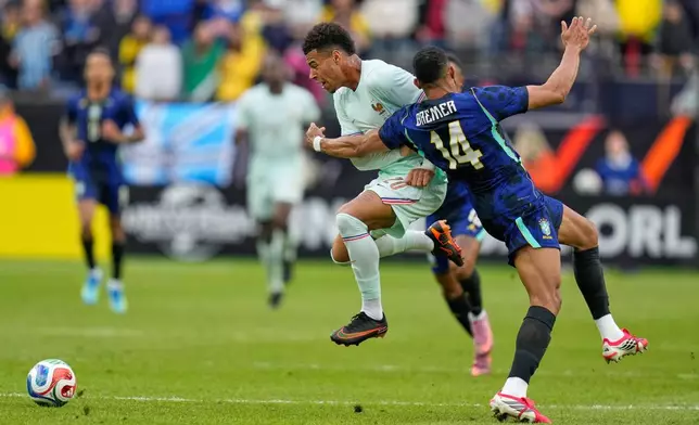 Desire Doue of France is fouled by Brazil's Bremer, right, during the international friendly soccer match between Brazil and France in Foxborough, Mass, Thursday, March 26, 2026. (AP Photo/Charles Krupa)