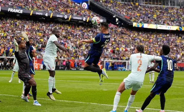Brazil's Casemiro, center, heads the ball during the international friendly soccer match between Brazil and France in Foxborough, Mass, Thursday, March 26, 2026. (AP Photo/Charles Krupa)