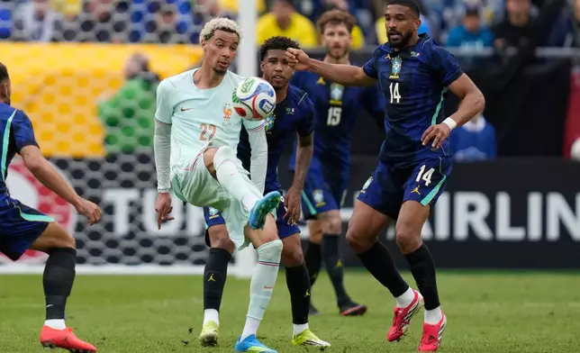 Hugo Ekitike of France controls the ball as Brazil's Bremer looks on during the international friendly soccer match between Brazil and France in Foxborough, Mass, Thursday, March 26, 2026. (AP Photo/Charles Krupa)