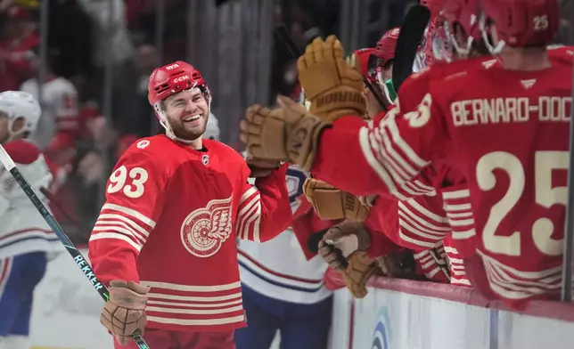 Detroit Red Wings right wing Alex DeBrincat (93) celebrates his goal against the MontrÈal Canadiens in the third period of an NHL hockey game Thursday, March 19, 2026, in Detroit. (AP Photo/Paul Sancya)