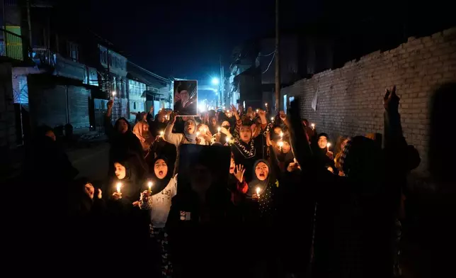 Shiite Muslims shout slogans during a candlelit protest against the killing of Iran's Supreme Leader Ayatollah Ali Khamenei, in Srinagar, Indian controlled Kashmir, Wednesday, March 4, 2026. (AP Photo/Mukhtar Khan)