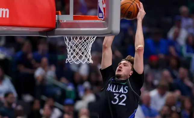Dallas Mavericks forward Cooper Flagg dunks in the first half of an NBA basketball game against the Minnesota Timberwolves Monday, March 30, 2026, in Dallas. (AP Photo/Gareth Patterson)