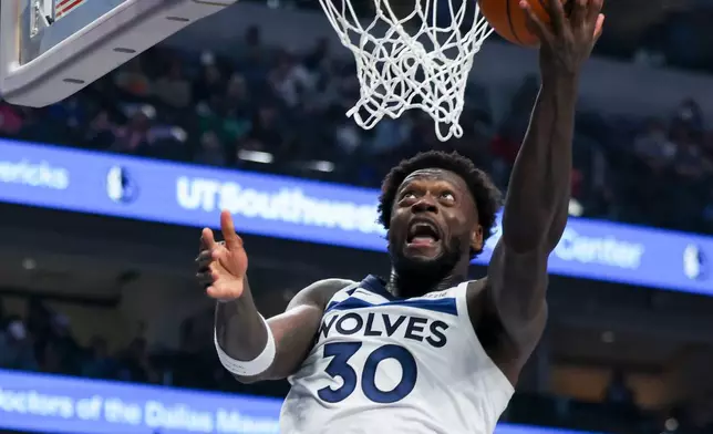 Minnesota Timberwolves forward Julius Randle goes up to score in the first half of an NBA basketball game against the Dallas Mavericks, Monday, March 30, 2026, in Dallas. (AP Photo/Gareth Patterson)