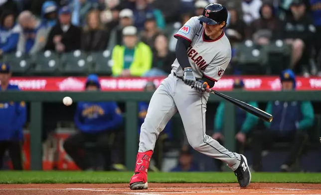 Cleveland Guardians' Chase DeLauter hits a solo home run against the Seattle Mariners during the first inning of a baseball game, Friday, March 27, 2026, in Seattle. (AP Photo/Lindsey Wasson)