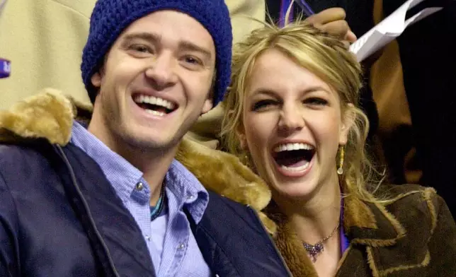 FILE - Justin Timberlake, left, and Britney Spears appear at the 2002 NBA All-Star game, in Philadelphia, Feb. 10, 2002. (AP Photo/Chris Gardner, File)