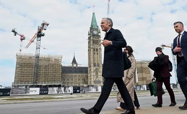 Canada's Prime Minister Mark Carney makes his way towards West Block on Parliament Hill in Ottawa, Ontario, Tuesday, March 10, 2026. (Spencer Colby/The Canadian Press via AP)