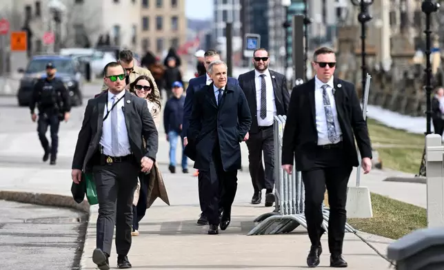Canada's Prime Minister Mark Carney makes his way towards West Block on Parliament Hill in Ottawa, Ontario, Tuesday, March 10, 2026. (Spencer Colby/The Canadian Press via AP)