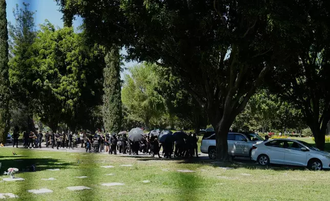 People follow the hearse carrying the remains of who authorities identify as the late Jalisco New Generation Cartel leader Nemesio Oseguera, alias "El Mencho," at Recinto de Paz cemetery for burial in Guadalajara, Mexico, Monday, March 2, 2026. (AP Photo/Refugio Ruiz)