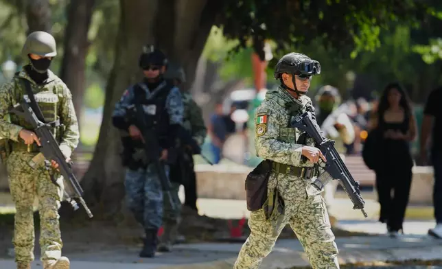 Mexican army soldiers patrol outside Recinto de Paz cemetery in Guadalajara, Mexico, Monday, March 2, 2026. (AP Photo/Refugio Ruiz)