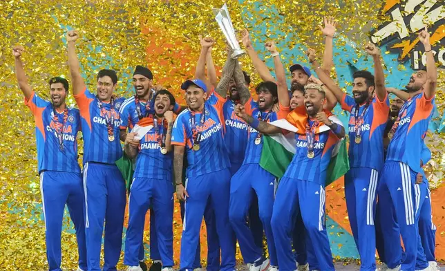 India's players celebrate with the trophy after winning the T20 World Cup final match against New Zealand, in Ahmedabad, India, Sunday, March 8, 2026. (AP Photo/Rafiq Maqbool)